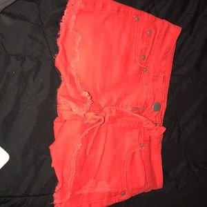 Ripped red booty shorts